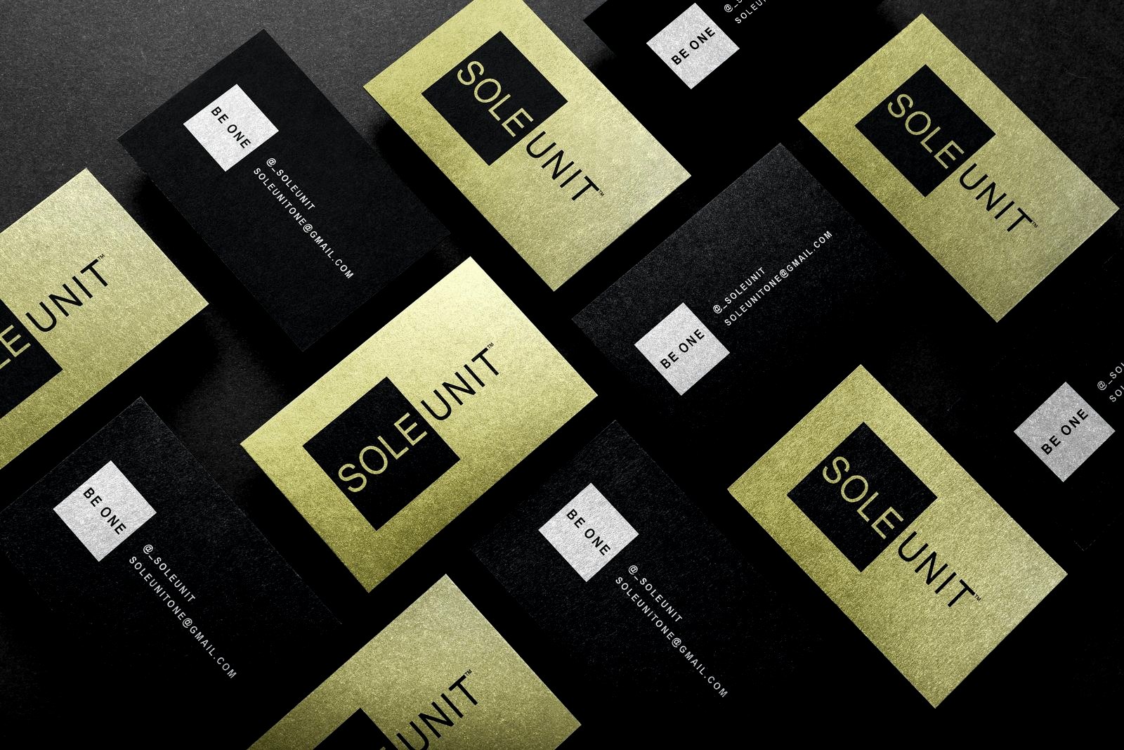 Sole Unit business cards, black and gold, laid in a diamond pattern