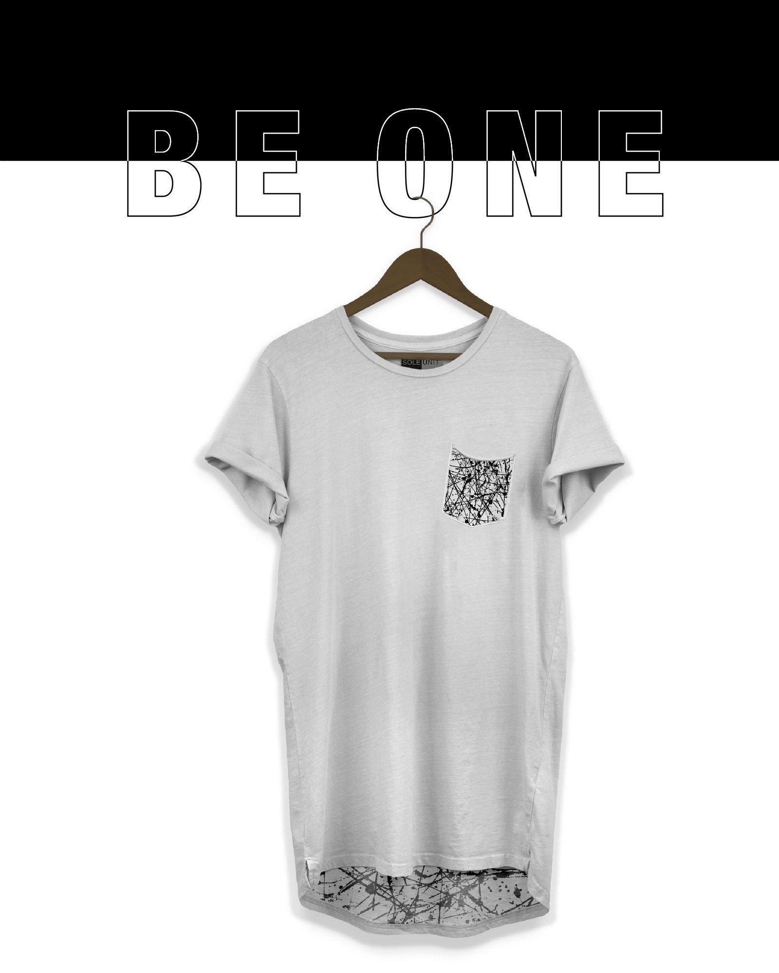 BE ONE outline type over a black-to-white split, white release tee on a hanger below
